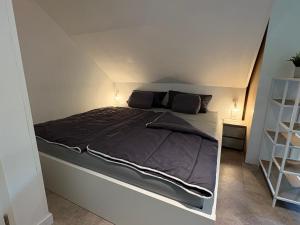 a large bed in a room with an attic at Nordwind in Langenhorn