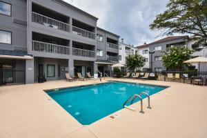 a swimming pool in front of a apartment building at Courtyard by Marriott Charlotte Matthews in Matthews