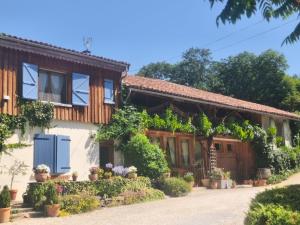 a house with a bunch of plants in front of it at Chambres d'hôtes St Jacques Adults only in Saint-Lizier