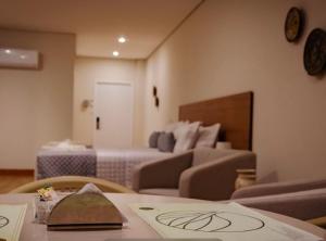 a hotel room with a couch and a bed at Amazon Seasons Suíte Premium em Belém in Belém