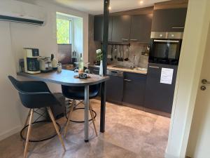 a kitchen with a small table and chairs in it at Nordwind in Langenhorn