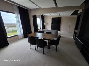 a dining room with a table and chairs in a room at Azahar Hotel & Spa in San Pedro