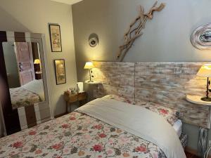 a bedroom with a bed and a large mirror at B&B Le Rupicapra in Roubion