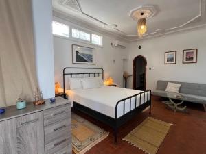 a bedroom with a large bed and a couch at Rayani Maison d'Hôtes in Chozas +60 photos