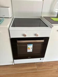 a kitchen sink in a white refrigerator at NovaStay in Breuillet +18 photos