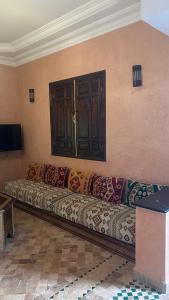a living room with a couch in a room at Villa Riad Ambre in Douar bel Rhanodour