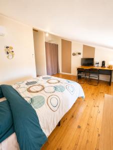 a bedroom with a large bed and a wooden floor at chambres d'hotes des capellas in Bessens