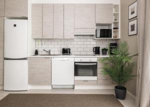 a kitchen with white appliances and a potted plant at Calm Design Studio with Balcony & Parking in Pori