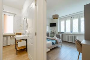 a bedroom with a bed and a sink in a room at Madame Bologna in Bologna