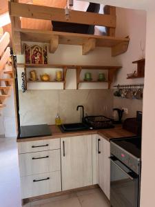 a kitchen with wooden cabinets and a stove top oven at Przy ścieżce in Węgierska Górka +15 photos