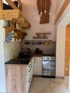 a kitchen with wooden cabinets and a stove at Przy ścieżce in Węgierska Górka