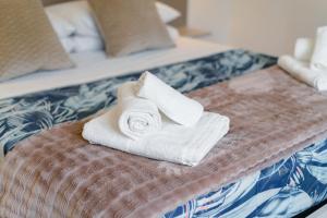 a pile of towels sitting on top of a bed at Madame Bologna in Bologna