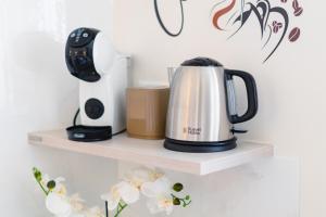 a coffee pot on a shelf with a blender at Madame Bologna in Bologna +43 photos