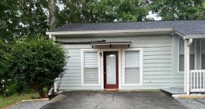 a small blue house with a red door at Tiny Home in Lawrenceville in Lawrenceville