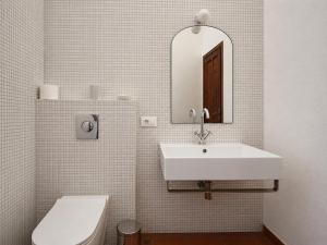 a bathroom with a sink and a toilet and a mirror at Villa Florineth in Simius +20 photos