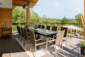 a patio with a table and chairs on a deck at Oakville House - Kosmaj - Avala in Mala Ivanča