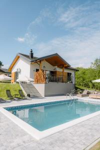 a swimming pool in front of a house at Oakville House - Kosmaj - Avala in Mala Ivanča