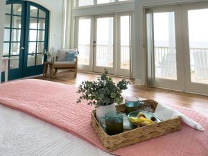 a tray of fruit and flowers on a bed with a table at Oceanfront/Zero Steps to Beach/Views/4BR in Gulf Shores