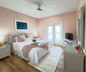 a bedroom with a large bed and a television at Oceanfront/Zero Steps to Beach/Views/4BR in Gulf Shores