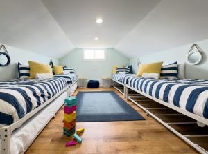 a row of beds in a room at Oceanfront/Zero Steps to Beach/Views/4BR in Gulf Shores