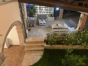 an outdoor patio with chairs and a table at Il Casale in Soiano del Lago