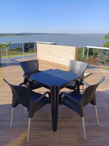 a blue table and two chairs on a deck at Hotel Diromani in Hernandarias