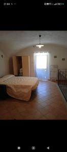 a bedroom with a large bed and a window at Casa Vacanza da Luigi in Opi