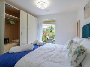 a bedroom with a large white bed with two pillows at Oakwood Annexe in Colchester