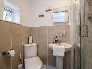 a bathroom with a toilet and a sink at Oakwood Annexe in Colchester +31 photos