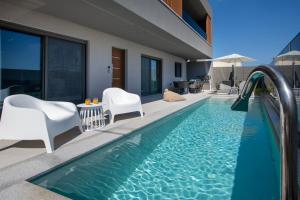 a pool with a water slide in a house at Villa Nectar in Kounoupidhianá