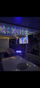 a room with a table and a tv with lights at Apartments Silva in Slatine +44 photos