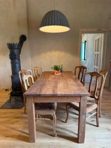 a wooden table and chairs with a candle on top at Zawiszyn 12 in Dubeninki