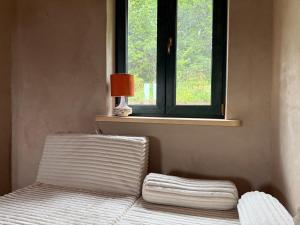 a bed in a room with a window at Zawiszyn 12 in Dubeninki