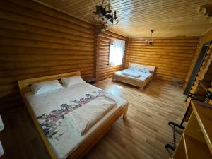 a bedroom with a bed and a bench in a room at Релакс in Svityazʼ +18 photos