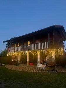 a house with christmas lights on the side of it at Релакс in Svityazʼ