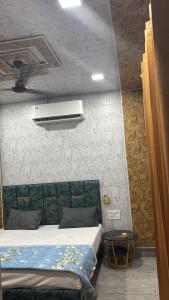 a bedroom with a bed and a air conditioner at Hotel Dhamija divine inn in Sirsa