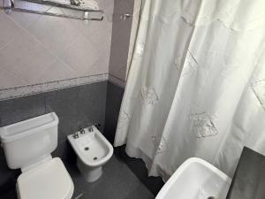 a bathroom with a toilet and a bidet at Marcopolo Suites Calafate in El Calafate +34 photos