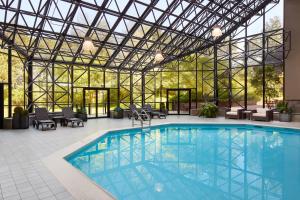 a pool in a building with a glass ceiling at Toronto Airport Marriott Hotel in Toronto