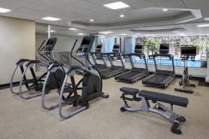 a gym with several treadmills and elliptical machines at Toronto Airport Marriott Hotel in Toronto