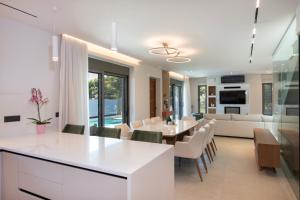 a dining room and living room with a table and chairs at Villa Nectar in Kounoupidhianá +64 photos