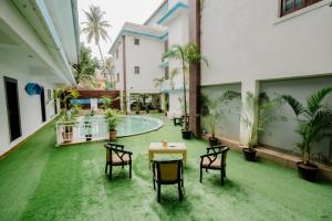 a room with a table and chairs and a pool at The Mint Calangute in Calangute