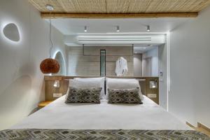 a bedroom with a large white bed with two pillows at Sirin Luxury Suites Groundfloor in Haraki