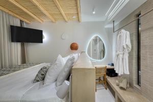 a bedroom with a large bed and a mirror at Sirin Luxury Suites Groundfloor in Haraki