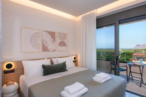 a bedroom with a bed with a view of a balcony at Villa Nectar in Kounoupidhianá