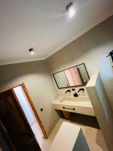 a bathroom with a sink and a mirror at Solymar Villa 3 in Jambiani