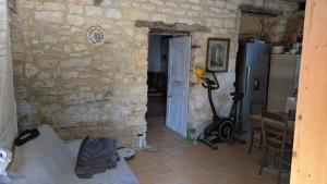 a living room with a stone wall and a door at Au soleil in Virac