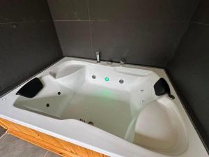 a large white bath tub in a room at Ayder Serender Otel in Çamlıhemşin +23 photos