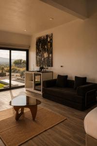 a living room with a couch and a coffee table at Sed de Valle-Valle de Guadalupe in Ensenada