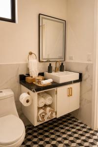 a bathroom with a sink and a toilet and a mirror at Sed de Valle-Valle de Guadalupe in Ensenada +12 photos