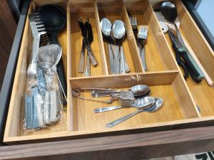 a wooden drawer filled with utensils and spoons at A un paso de Laurel Estudio con balcón in Logroño